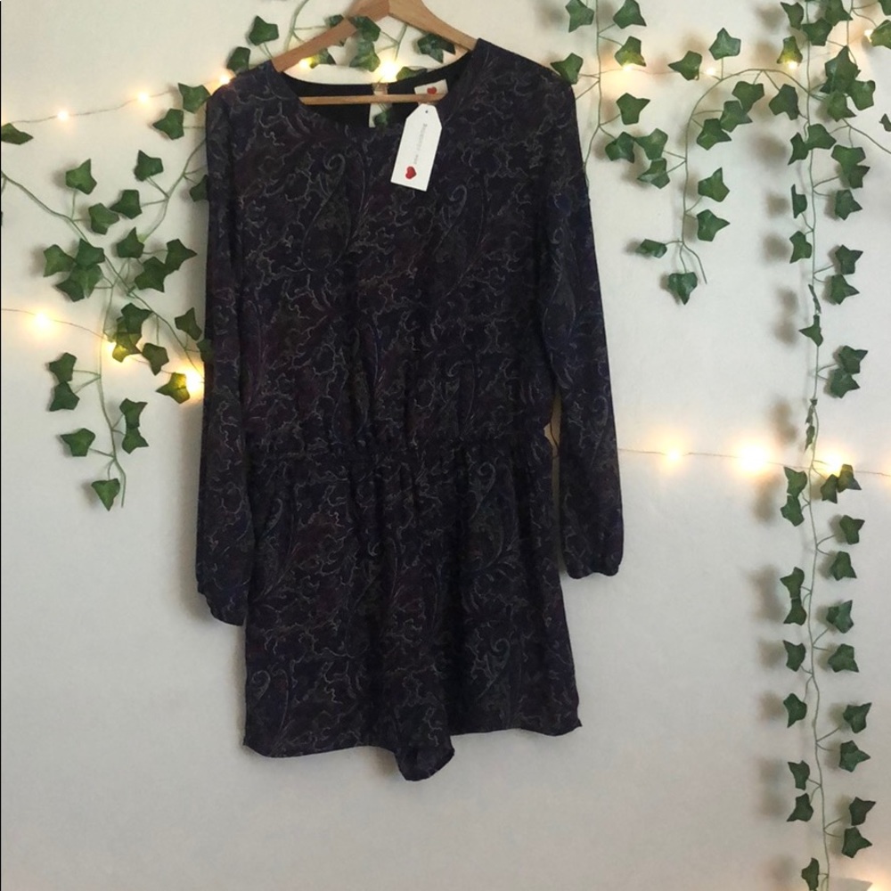 purple romper with designs on it